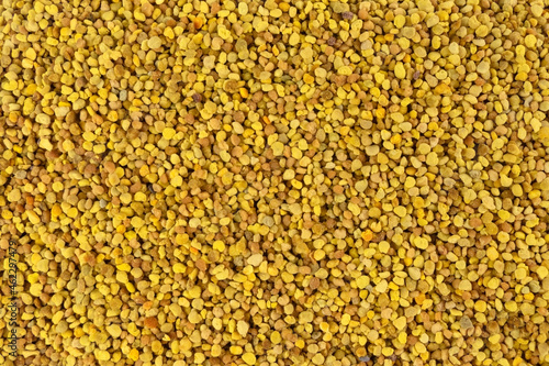 Bee pollen background. Natural herbal medicine to relieve inflammation, influenza, boosts liver health, strengthens immune system, reduces stress and used as a dietary supplement.