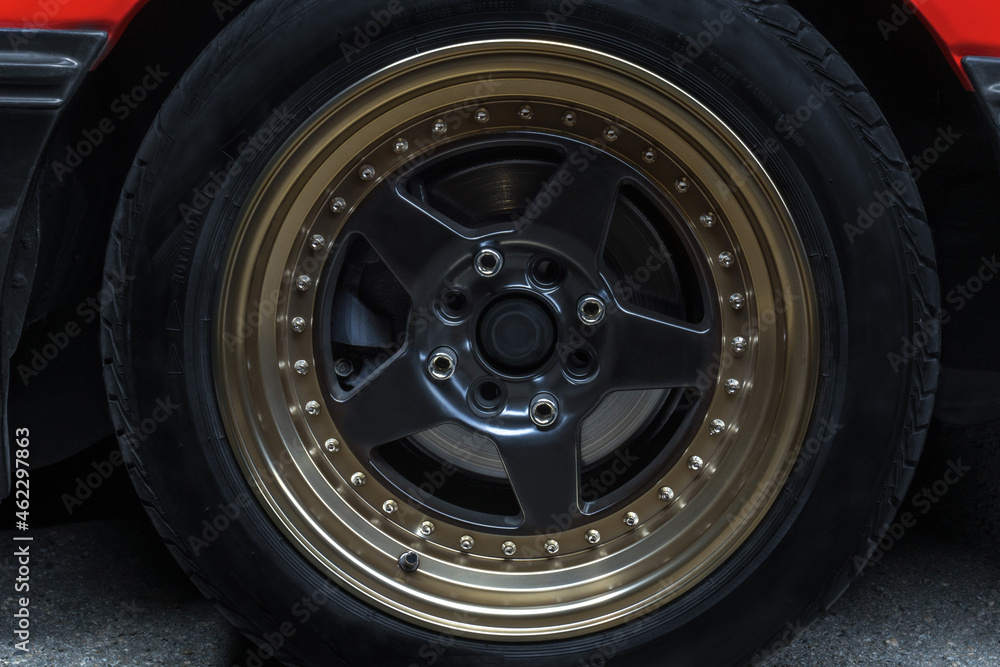 Fototapeta premium red old racing car on stylish titanium rims