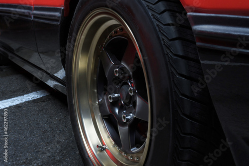 red old racing car on stylish titanium rims