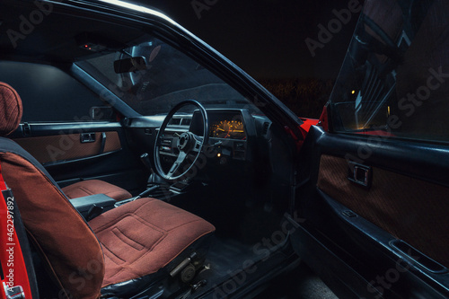 red old racing car inside tuning sports steering wheel © yurii oliinyk