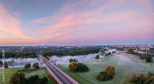 Sunrise and the first rays of sunshine over the fog-covered Ruhr meadows in Duisburg, Germany