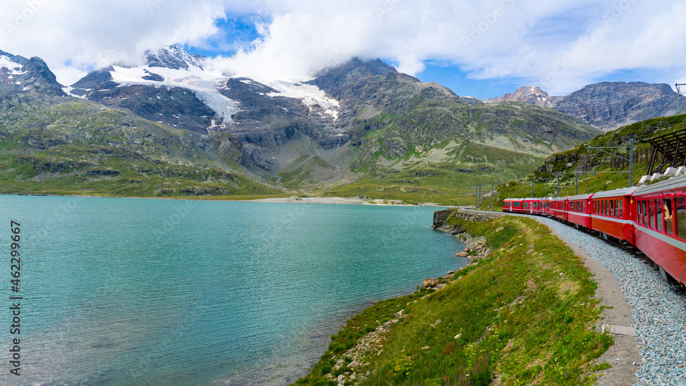 Bernina red train in and alpine lake