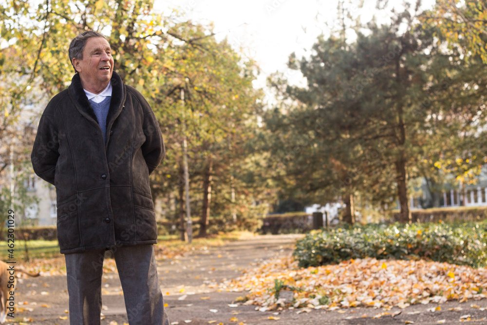 Senior man enjoying taking a walk in nature Senior man enjoying taking a walk in nature