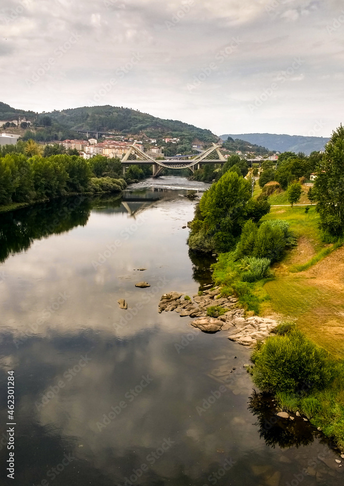 Fototapeta premium landscape with river in the mountains. Millennium Bridge over the river Miño
