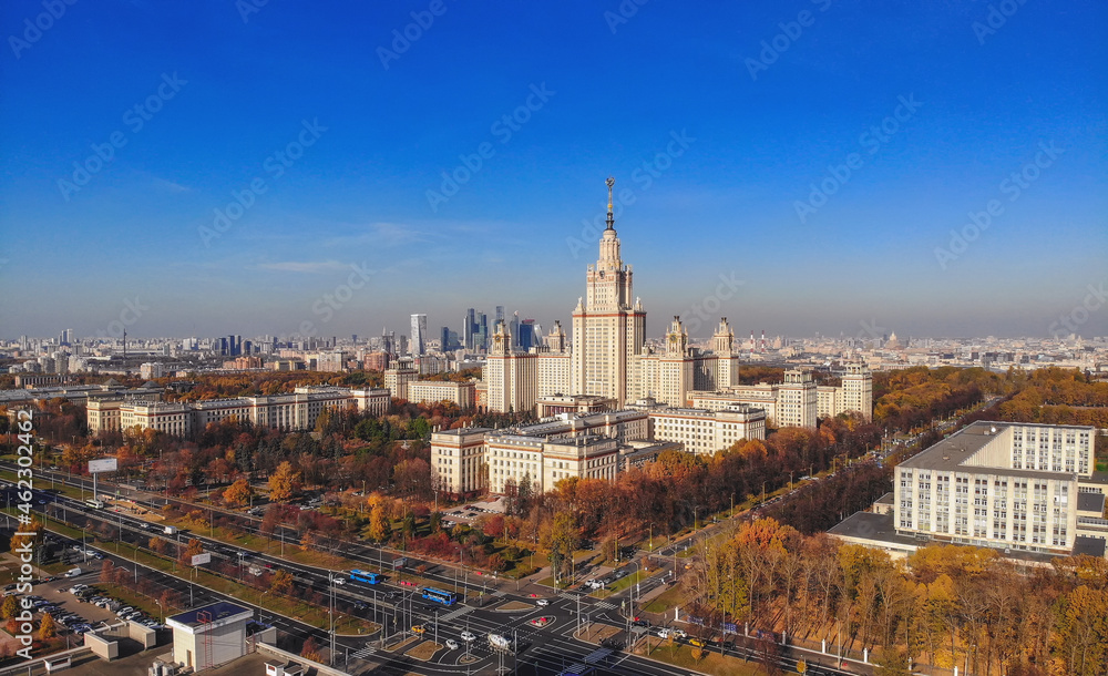 Aerial dron panoramic view of campus buildings of famous Moscow university under blue  sky in early autumn