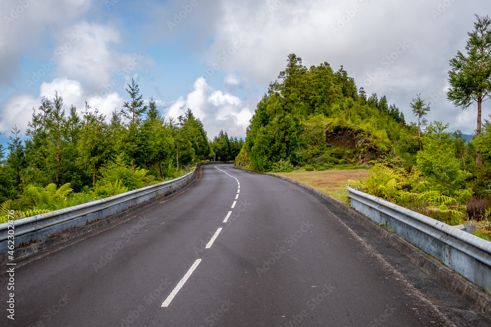 Empty asphalt road with green vegetation in Lagoa do Fogo (Fire Lake) at São Miguel, Azores - Portugal