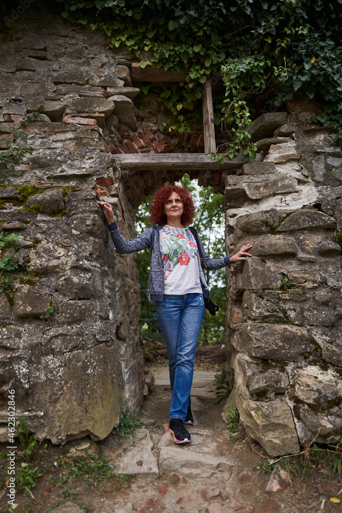 Tourist woman with camera in a ruined fortress Tourist woman with camera in a ruined fortress