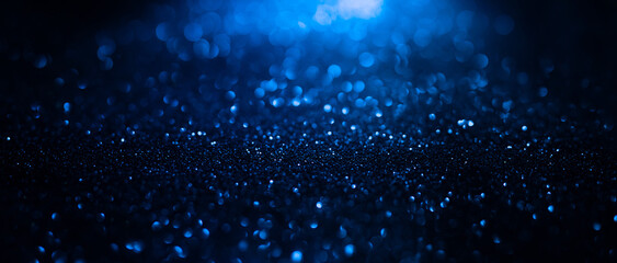 Abstract background of blue glitter lights. De-focused background. Banner size