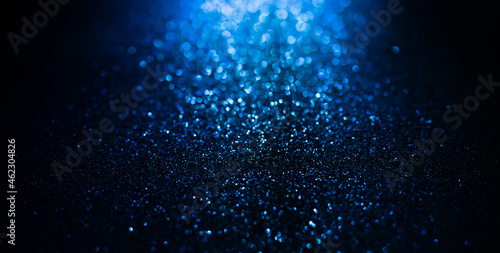 Abstract background of blue glitter lights. De-focused background. Banner size