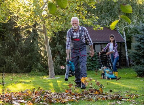 Father and daughter working in garden in autumn photo