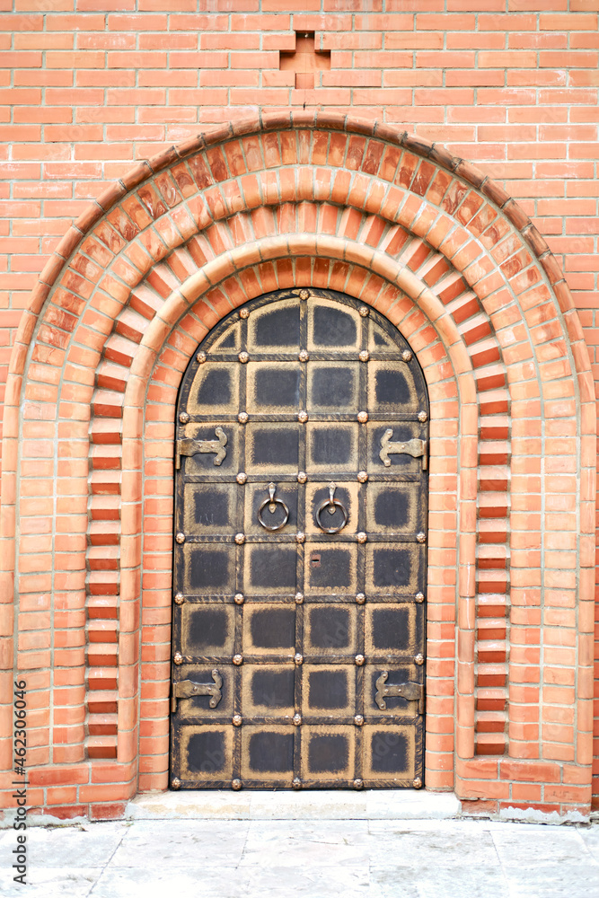 The door of a vintage church in the Old Russian style in a red brick wall