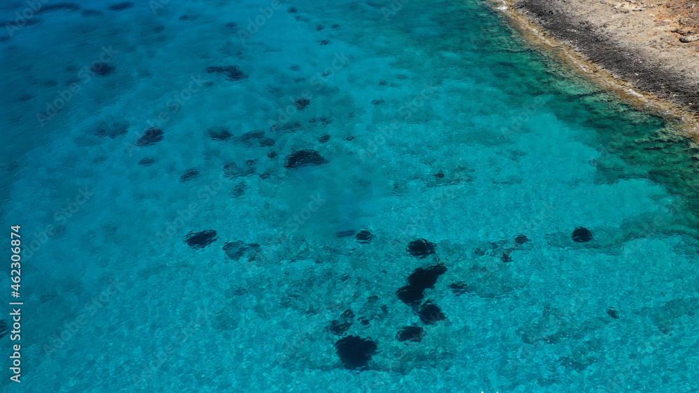 Aerial drone photo of tropical exotic paradise bay with deep turquoise sea and caves forming a blue lagoon visited by luxury yachts and sail boats Aerial drone photo of tropical exotic paradise bay with deep turquoise sea and caves forming a blue lagoon visited by luxury yachts and sail boats