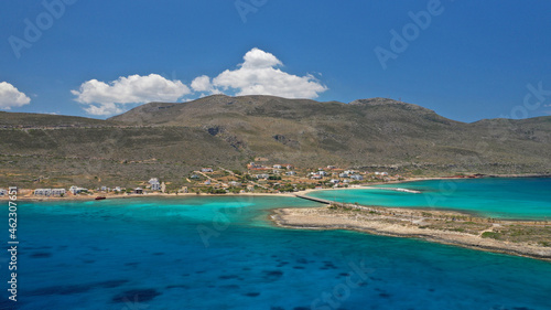 Fototapeta Naklejka Na Ścianę i Meble -  Aerial drone photo of main port of Kythera island and turquoise exotic beach of Diakofti, Ionian, Greece
