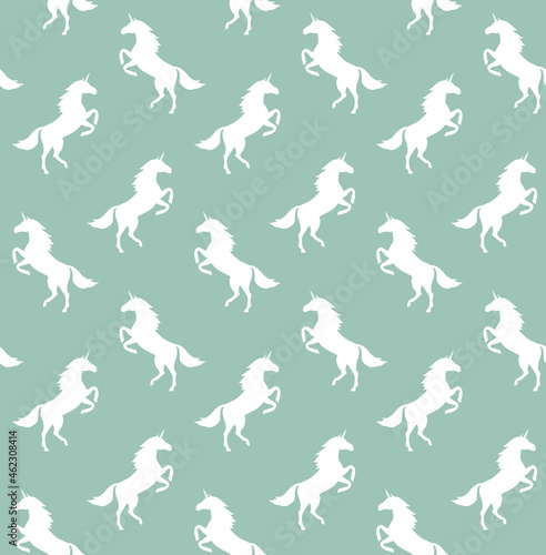 Vector seamless pattern of flat unicorn silhouette isolated on mint green background