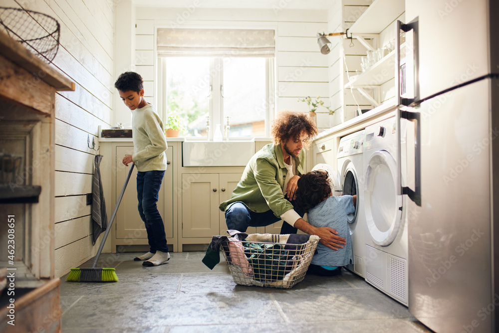 Two boys helping father with household chores Two boys helping father with household chores