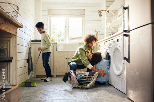 Two boys helping father with household chores photo