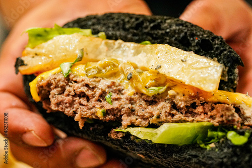 Black burger with delicious patties and cheese