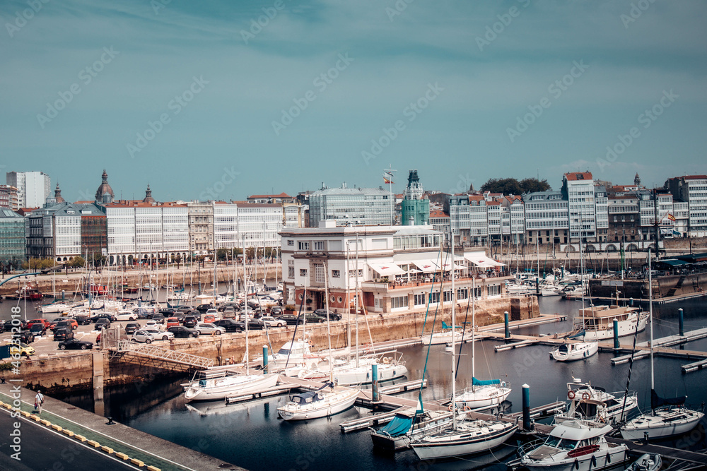 Yacht port in the center of La Coruña Galicia. White yachts on the background of houses, summer.