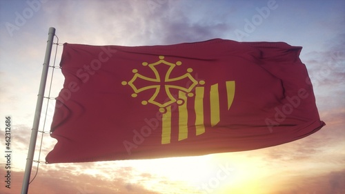 Languedoc-Roussillon flag, France, waving in the wind, sky and sun background. 3d rendering photo