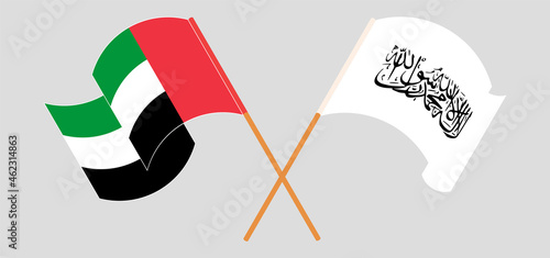 Crossed and waving flags of the United Arab Emirates and Taliban