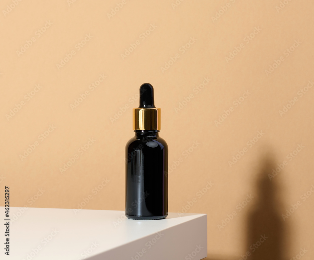 brown glass bottle with pipette stands on a white table. Cosmetics SPA branding. Packaging for gel, serum, advertising and product promotion brown glass bottle with pipette stands on a white table. Cosmetics SPA branding. Packaging for gel, serum, advertising and product promotion