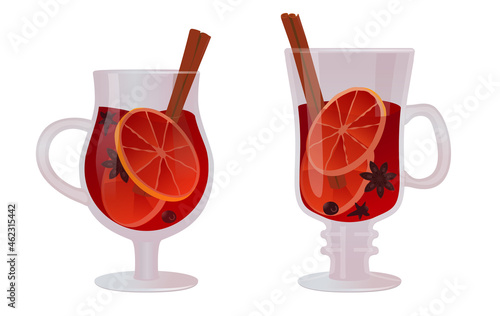 Set of two glasses of Christmas mulled wine with spices and fruits. Traditional hot beverage. 