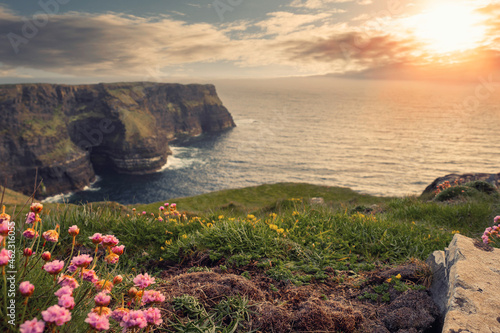 Spectacular scenery of Cliff of Moher, county Clare, Ireland. Warm sunny day. cloudy sky. Irish landscape.