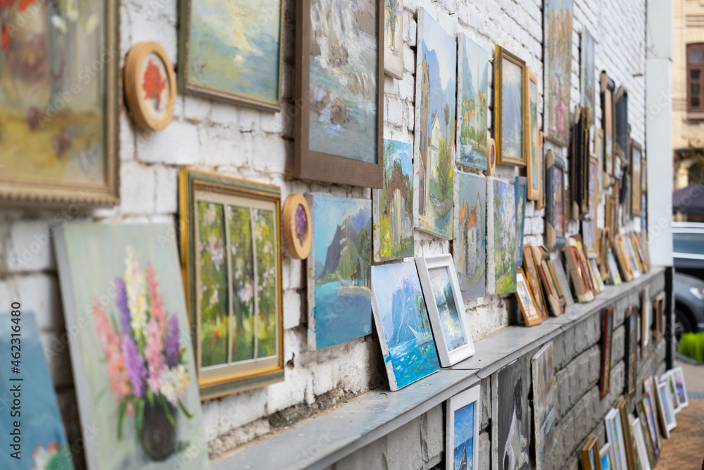 Fototapeta premium Exhibition of paintings in the central square of the city. Exhibition on the wall
