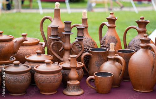Earthenware at market. Jugs, plates, jugs, bottles from clay