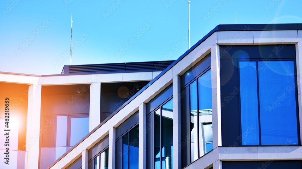 Modern office building with glass facade on a clear sky background. Transparent glass wall of office building. Modern office building with glass facade on a clear sky background. Transparent glass wall of office building.