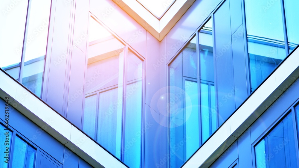 Modern office building with glass facade on a clear sky background. Transparent glass wall of office building. Modern office building with glass facade on a clear sky background. Transparent glass wall of office building.