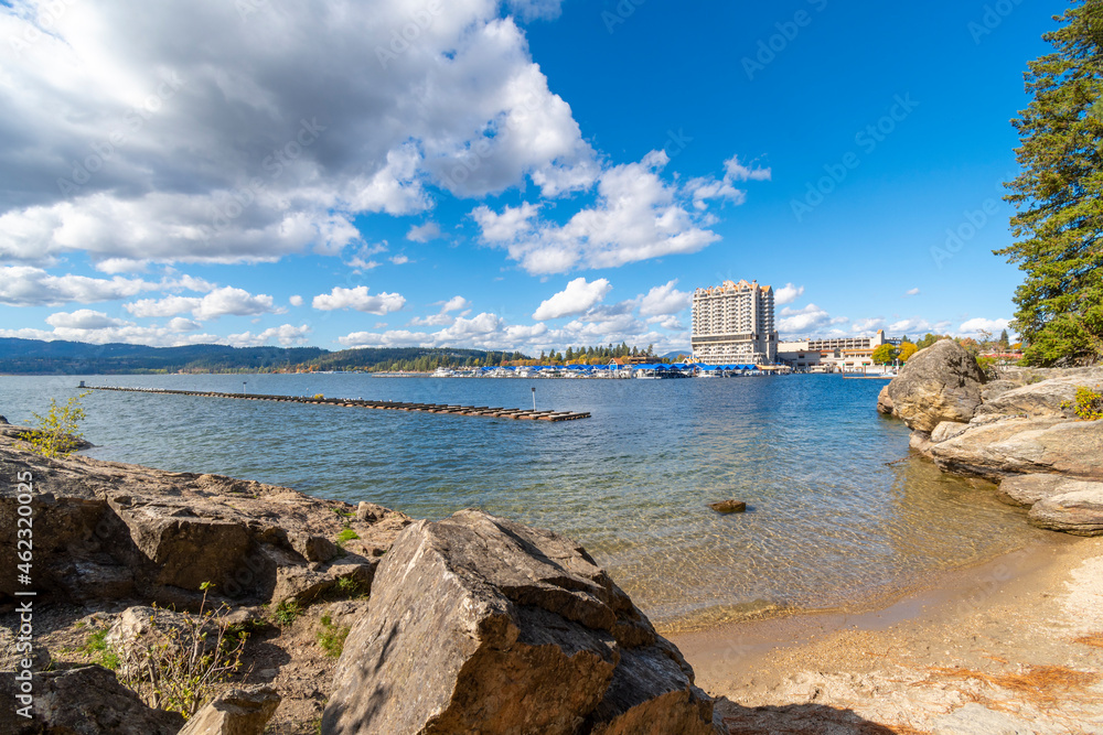 View of downtown Coeur d'Alene, the marina, city beach and park from a small beach on the lake at Tubbs Hill in Coeur d'Alene, Idaho, USA at autumn