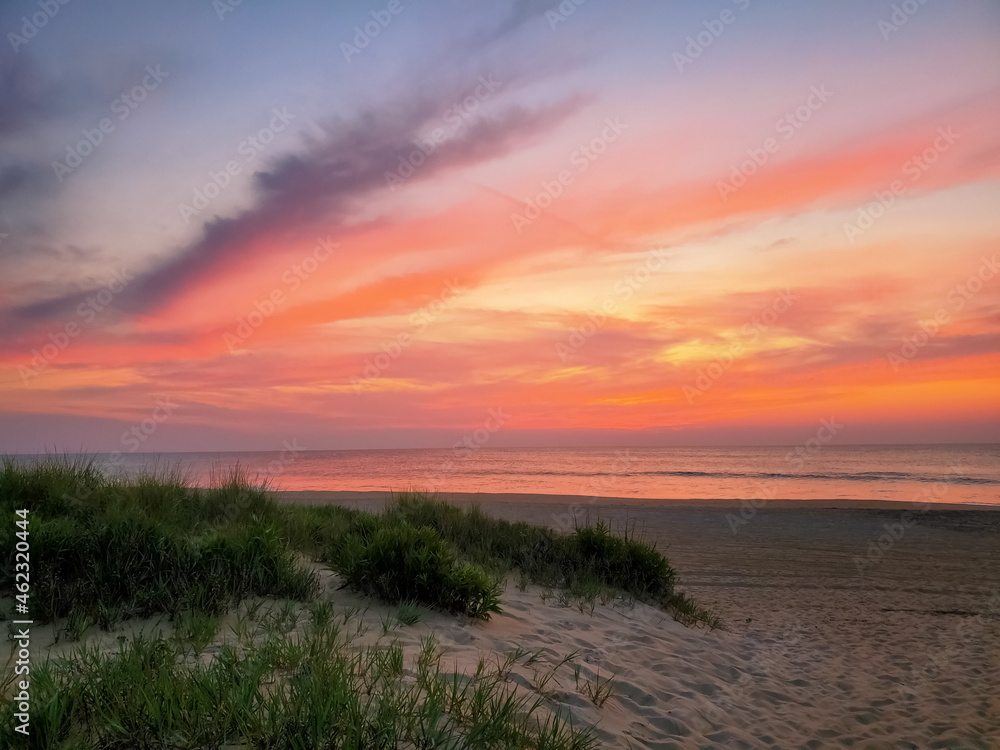 sunset over beach with sand