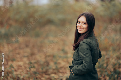 Woman with Hand in her Pockets Looking at Autumn Landscape