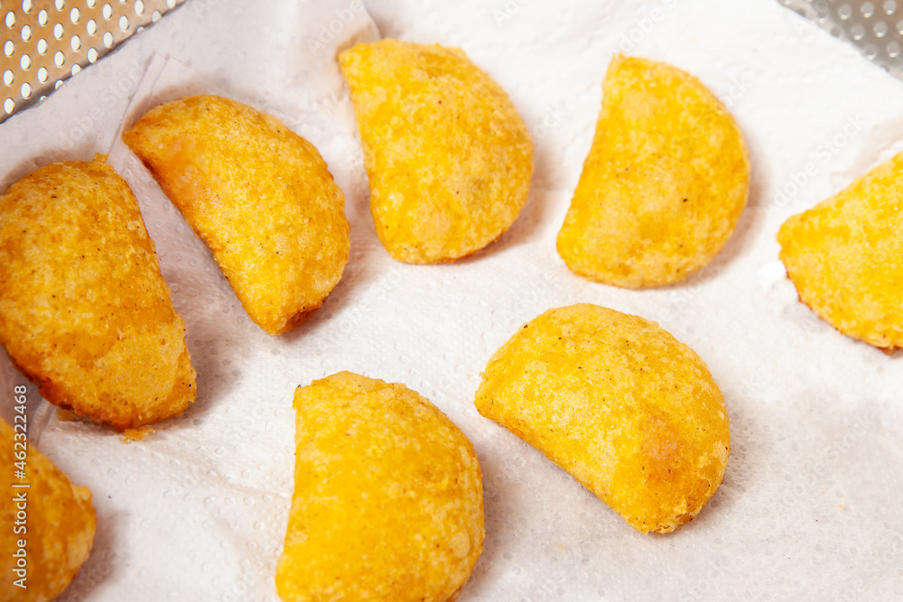 Preparation of the traditional patties from the region of Cauca in Colombia, called empanadas de pipián - Just fried patties Preparation of the traditional patties from the region of Cauca in Colombia, called empanadas de pipián - Just fried patties