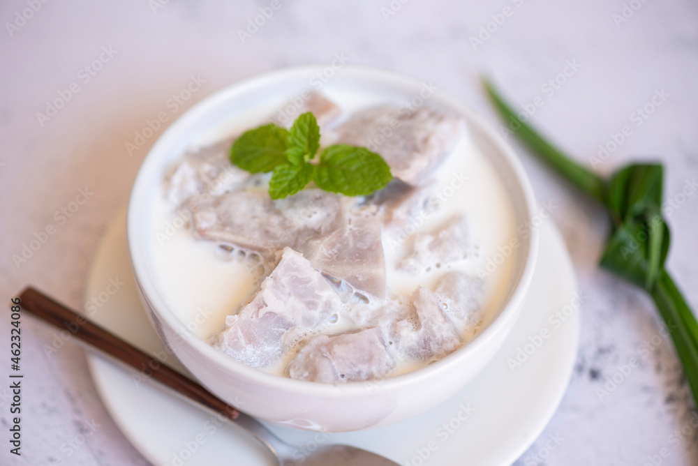 Taro food with dessert taro boiled with sugar and coconut milk on bowl and fresh raw organic taro root ready to cook, Asian Thai food Taro food with dessert taro boiled with sugar and coconut milk on bowl and fresh raw organic taro root ready to cook, Asian Thai food