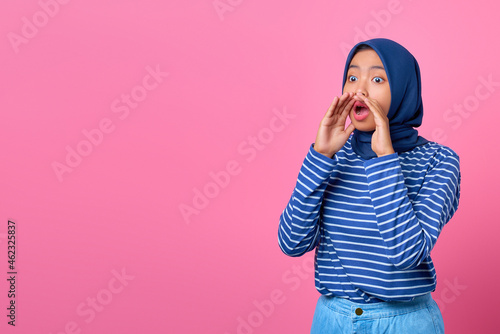 Portrait of screaming young Asian woman with shocked expression