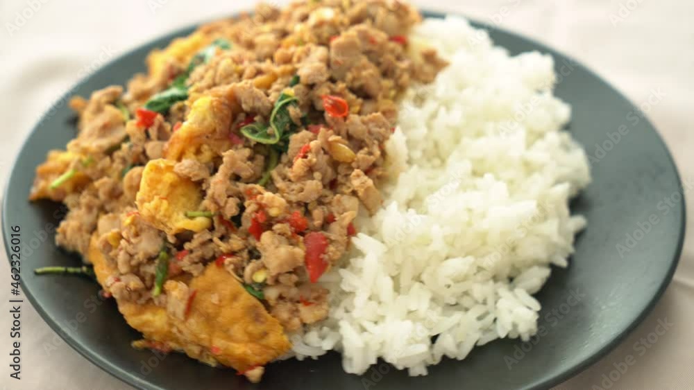 stir-fried minced pork with basil and egg topped on rice - Asian food style stir-fried minced pork with basil and egg topped on rice - Asian food style
