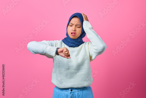 Portrait of young Asian woman worried work deadline stress on pink background © Sewupari Studio