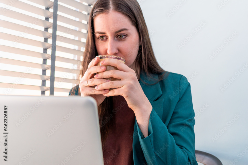 Young woman in suite is working on computer. Young woman in suite is working on computer.