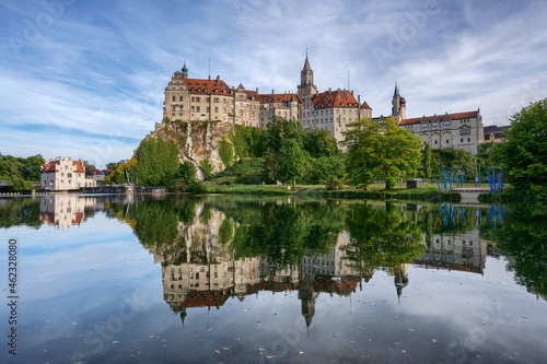 Hohenzollern Castle in Sigmaringen, Germany is reflected in the water of the Danube river at daytime
