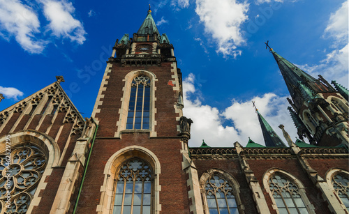 huge Gothic architecture church building landmark travel destination and sightseeing point of Lviv Wester Ukraine part foreshortening from below on sky background