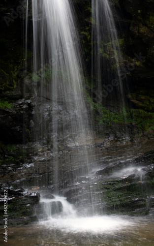 Waterfalls cascading over rocks in the forest.