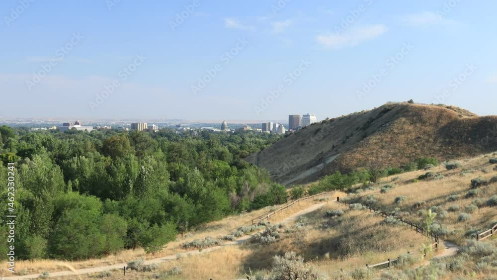 A view of downtown Boise, Idaho as seen from Camel’s Back Park on a sunny, summer day. A network of sandy trails is seen crisscrossing foothill slopes covered in dry grasses. A view of downtown Boise, Idaho as seen from Camel’s Back Park on a sunny, summer day. A network of sandy trails is seen crisscrossing foothill slopes covered in dry grasses.