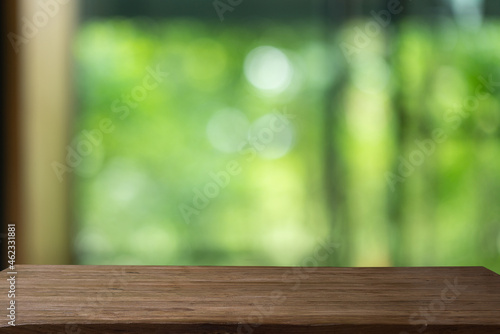 empty on wood table on green background.