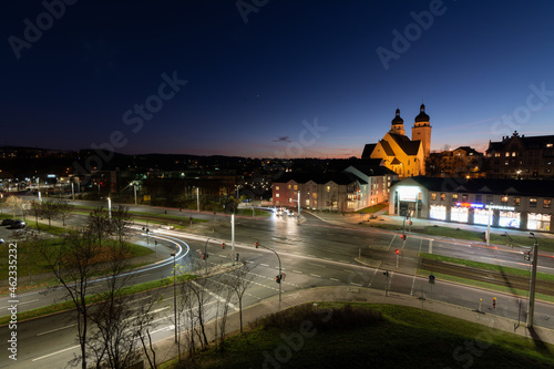 colorful light stripes of cars on the street at night in front of a church in the city of plauen © klickit24