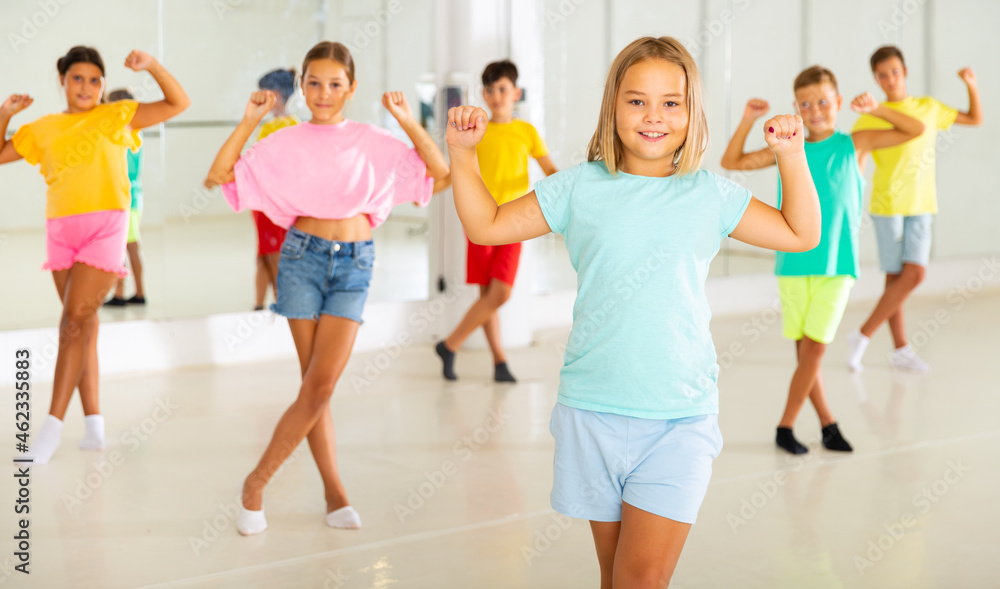 Children exercising dance moves together during their group classes.