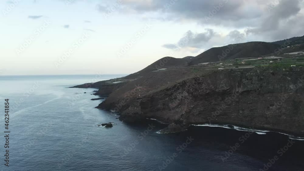 Drone shot rugged sea cliffs on Canary Island, Spain, with clouds in the sky Drone shot rugged sea cliffs on Canary Island, Spain, with clouds in the sky