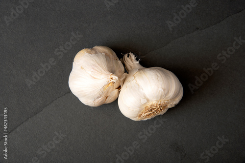 Whole garlic bulbs on a dark slate countertop