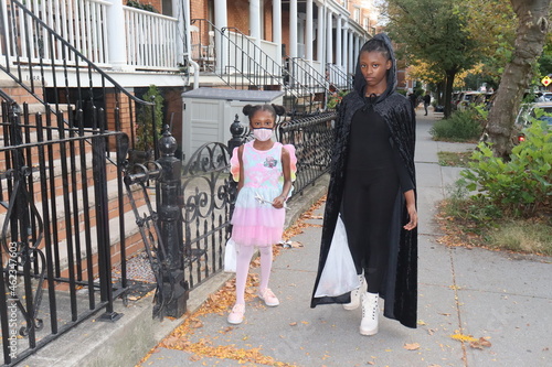 Black Girls in Halloween Costumes walking city sidwalk photo